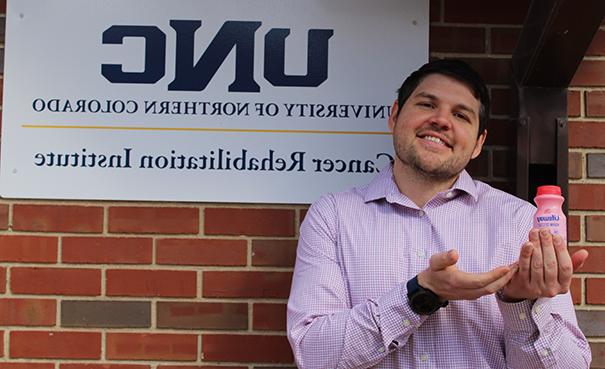 Peter Smoak outside UNCCRI holding a bottle of kefir.